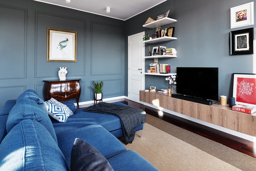 Living room with blue walls, contemporary sofa and deco style